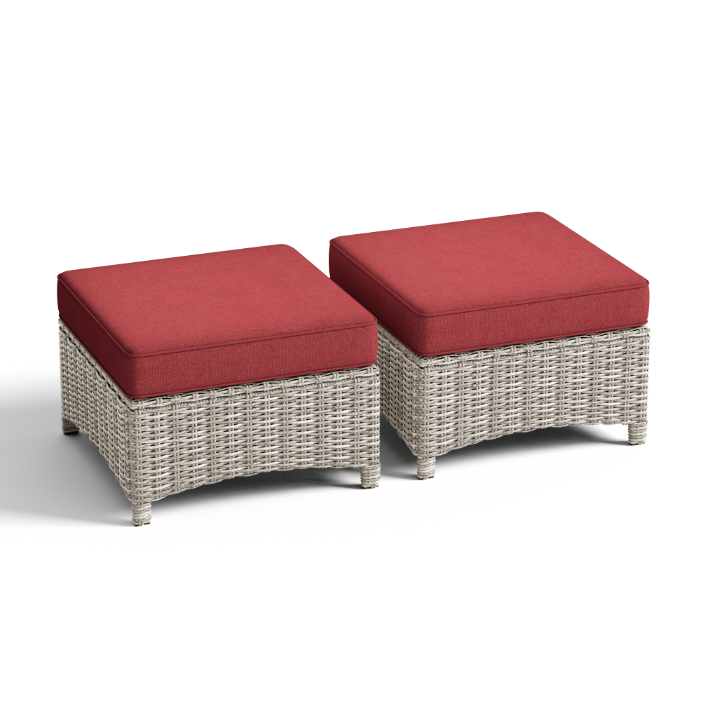Two wicker ottomans with red cushions on a white background