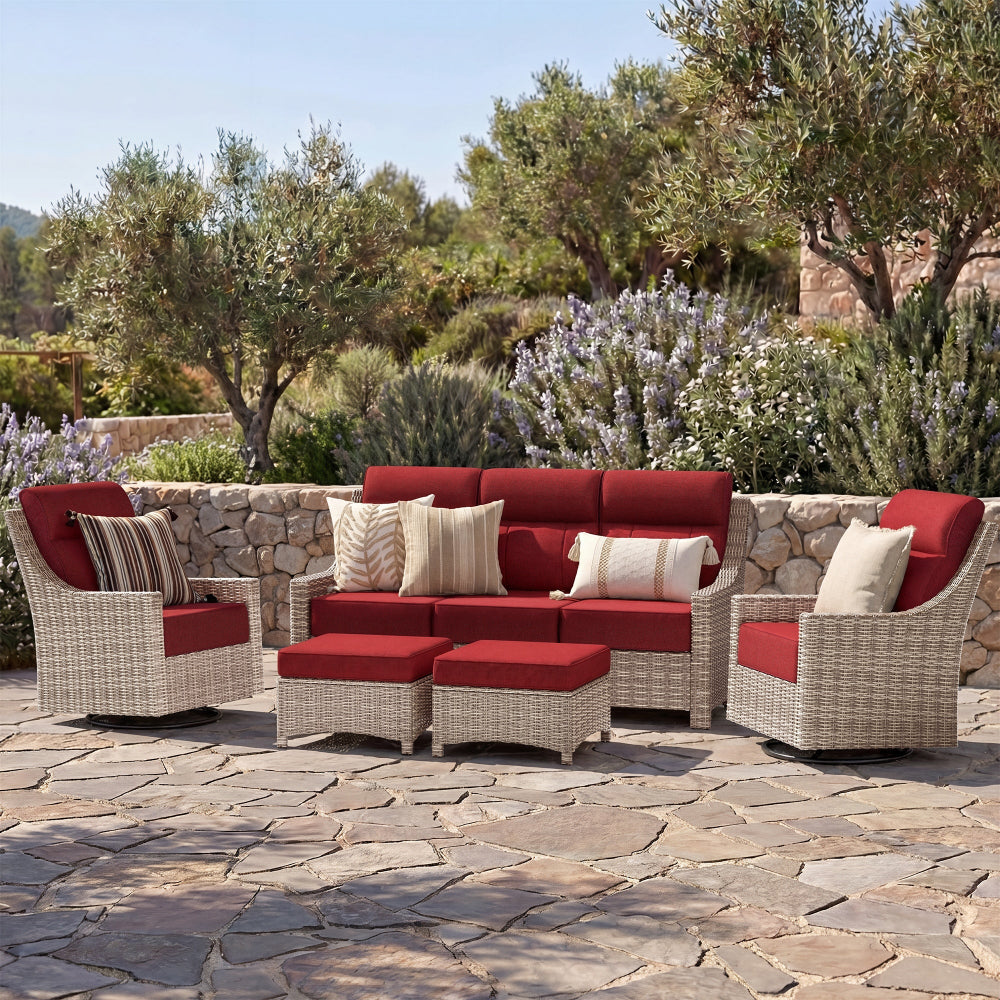 Outdoor patio furniture set with red cushions on a stone patio