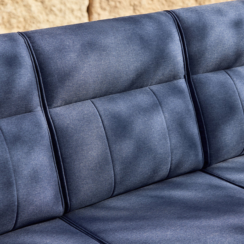 Close-up of a blue sofa with a textured fabric surface.