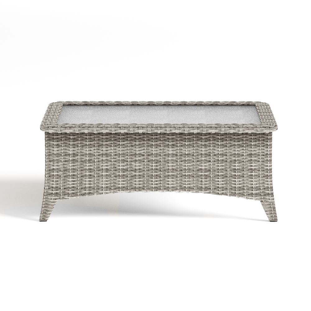 Wicker coffee table with glass top on a white background
