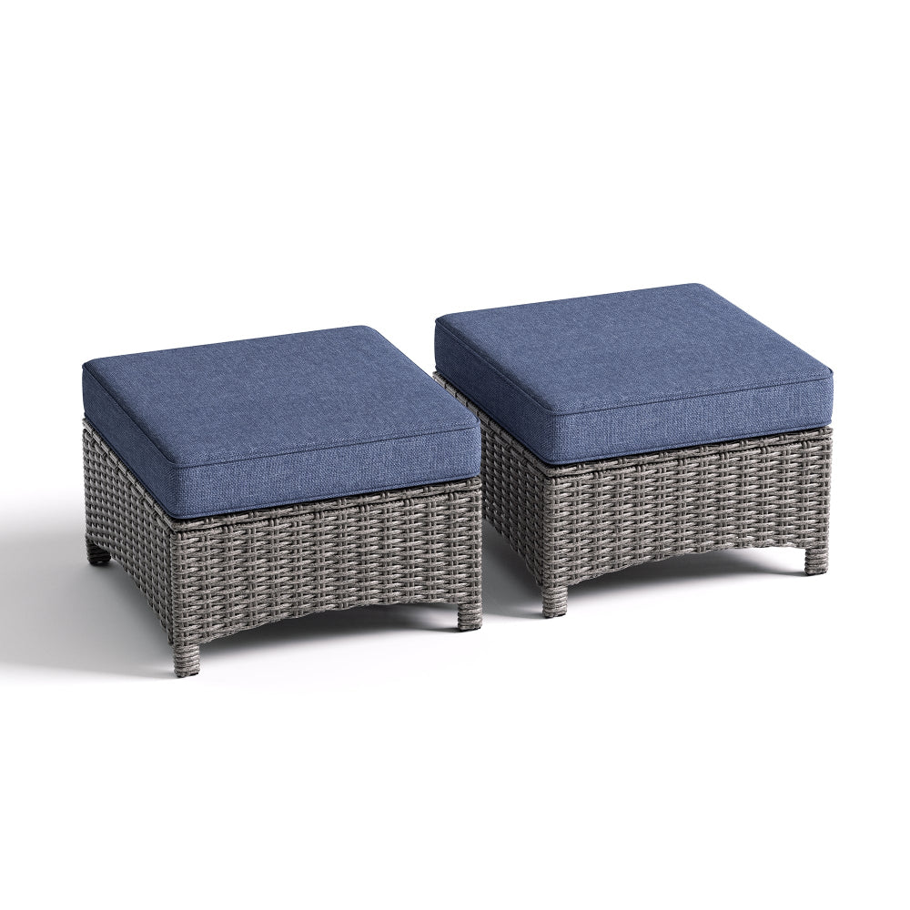 Two wicker ottomans with blue cushions on a white background