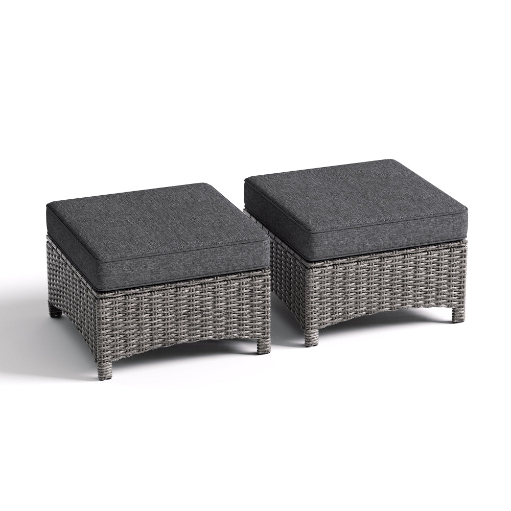 Two gray wicker ottomans with dark cushions on a white background