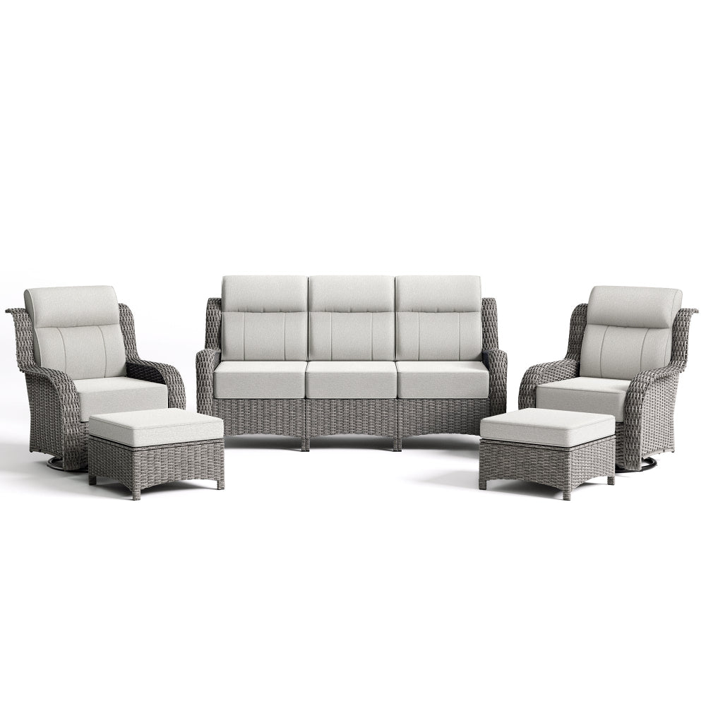 Outdoor furniture set with gray wicker frames and white cushions on a white background