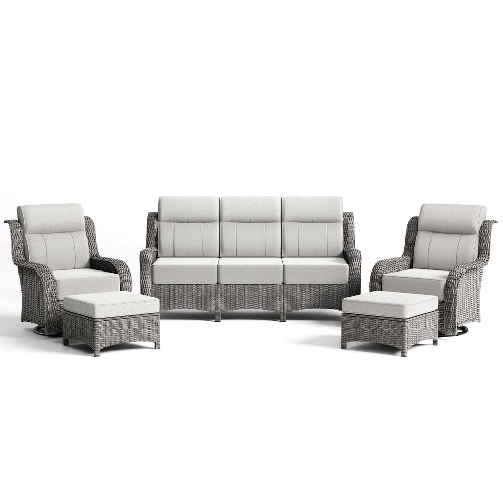 Outdoor furniture set with gray wicker frames and white cushions on a white background