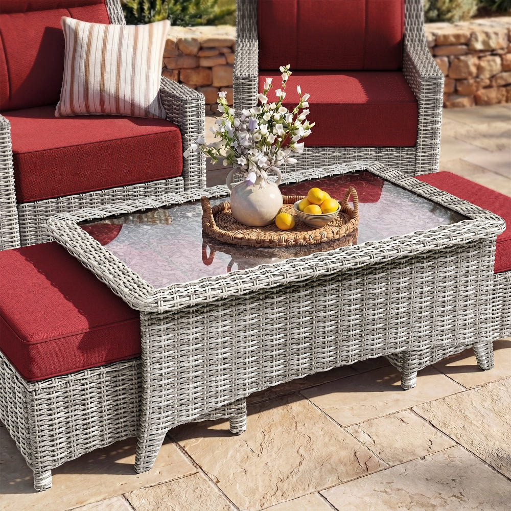 Outdoor patio set with wicker chairs and table on a stone patio