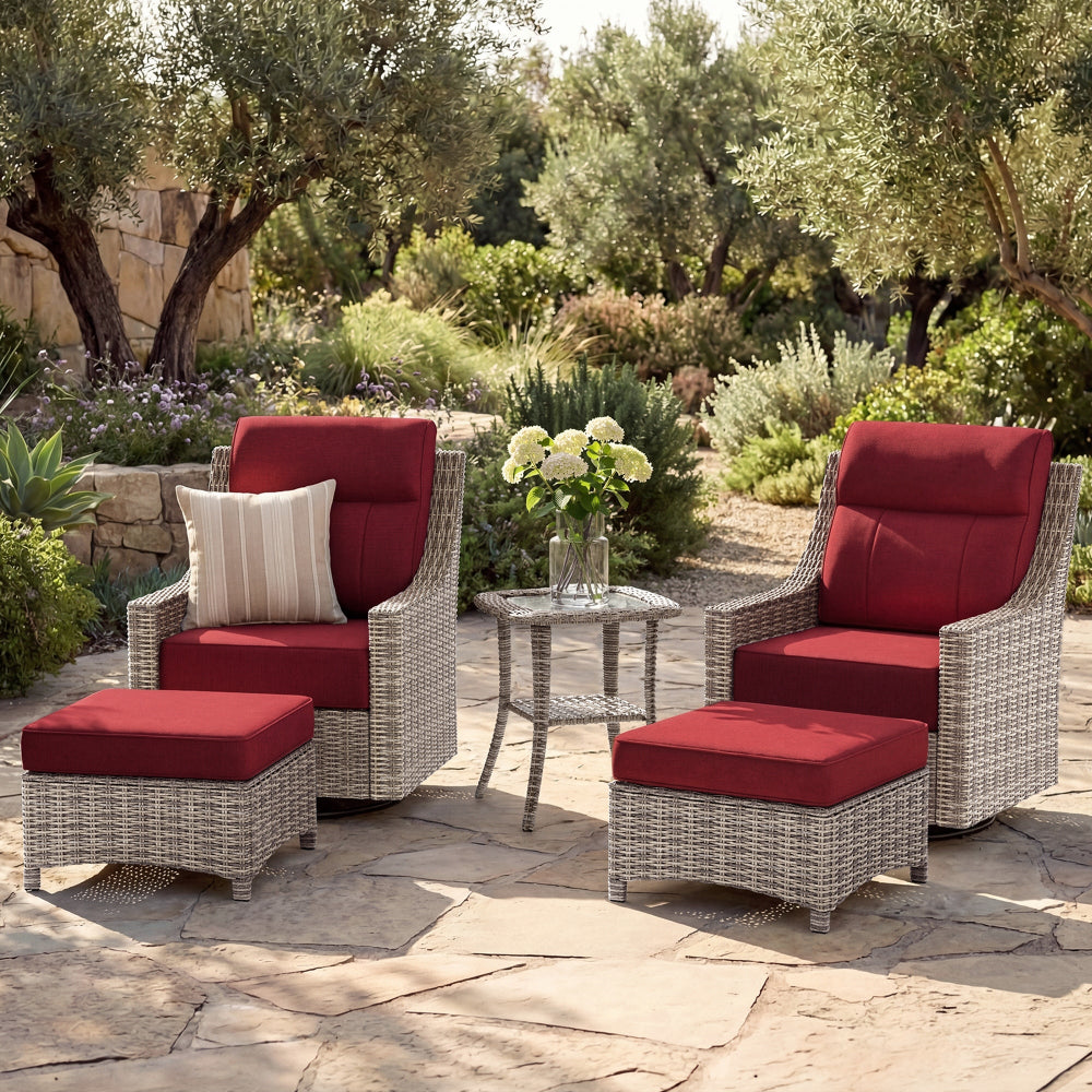 Outdoor patio set with red cushions on a stone patio surrounded by trees and plants.