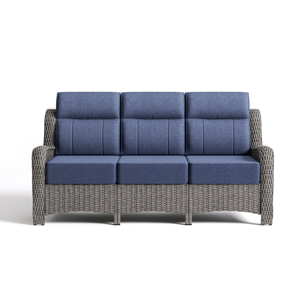 Gray wicker outdoor sofa with blue cushions on a white background