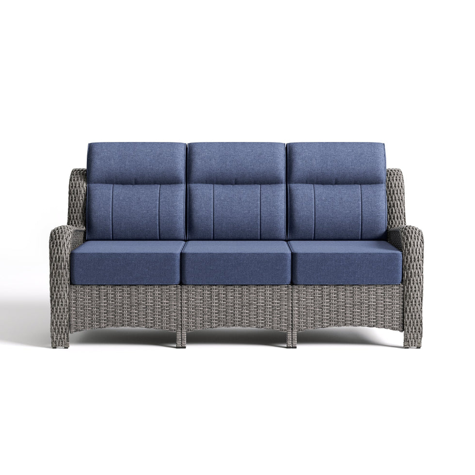 Gray wicker outdoor sofa with blue cushions on a white background