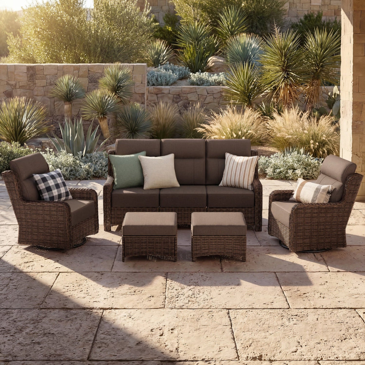 Outdoor patio furniture set with cushions on a stone patio