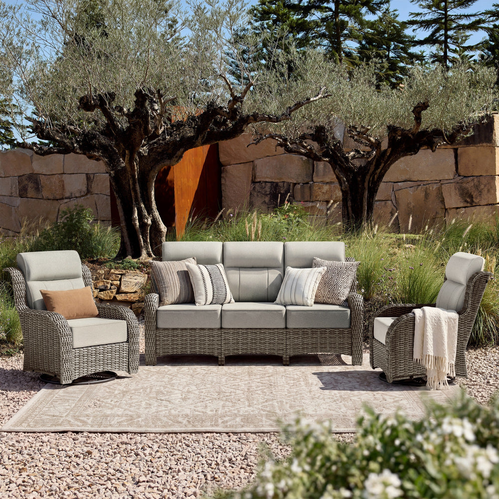Outdoor patio furniture set with cushions in a garden setting.